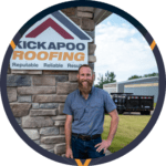 Professional roofer standing next to Kickapoo Roofing company sign