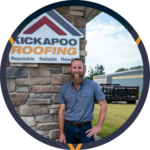 Professional roofer standing next to Kickapoo Roofing company sign